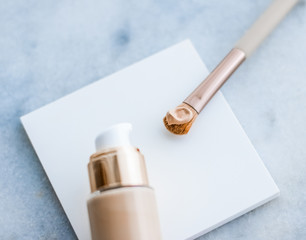 Makeup foundation bottle and contouring brush on marble, make-up concealer bb cream as cosmetics product for luxury beauty brand holiday design