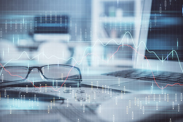 Financial chart hologram with glasses on the table background. Concept of business. Double exposure.