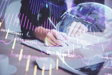 Forex graph on hand taking notes background. Concept of research. Multi exposure
