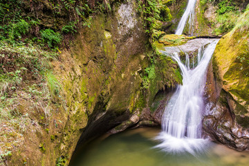 Fototapeta na wymiar Caglieron caves and waterfalls. Magic of emerald. Vittorio Veneto, Italy