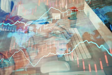 Double exposure of stock market chart with man working on computer on background. Concept of financial analysis.