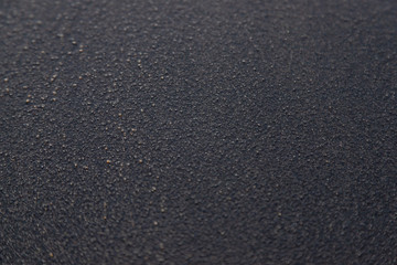 Soft smooth Black sand texture on the beach with pebble around, soft focus for background