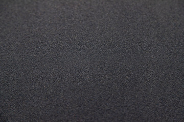 Soft smooth Black sand texture on the beach with little pebble spread around for background