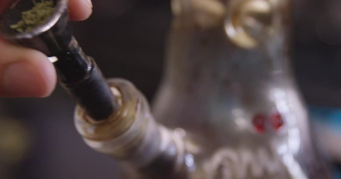 Close Up - A bowl packed with cannabis is removed and returned to a bong - shot on RED