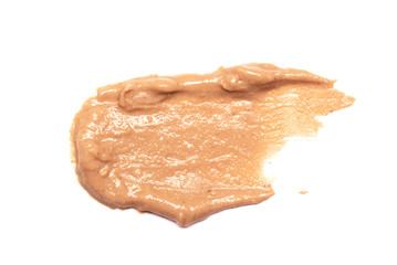 Brown peanut butter smear isolated on white background.