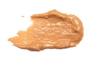 Brown peanut butter smear isolated on white background.