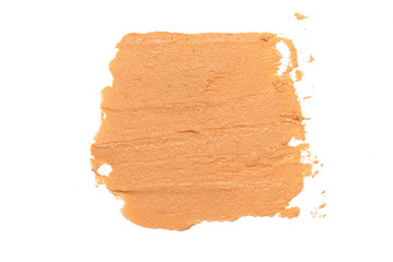 Brown peanut butter smear isolated on white background.