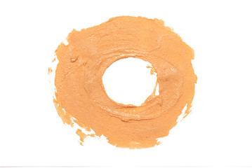 Brown peanut butter smear isolated on white background.