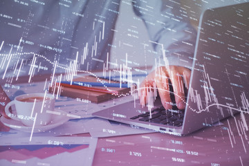 Forex graph with businessman working on computer in office on background. Concept of hardworking. Multi exposure.