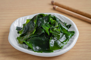 Wakame seaweed on white plate