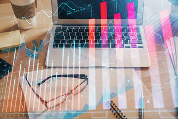 Financial graph colorful drawing and table with computer on background. Double exposure. Concept of...