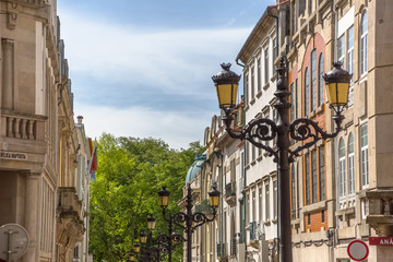 Detailed view of classic retro street lamp post, on metal material, ornamented and with two heads