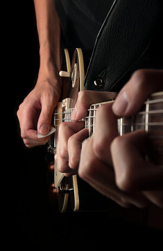 Three Hands Playing Guitar
