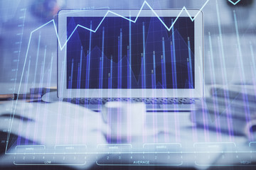 Forex market chart hologram and personal computer background. Multi exposure. Concept of investment.