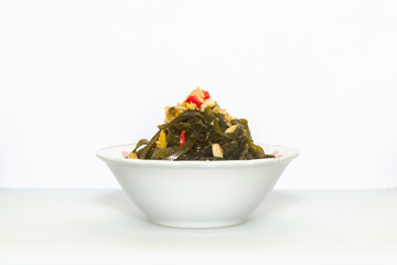 Shredded seaweed salad served in a white China bowl