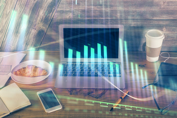 Multi exposure of graph and financial info and work space with computer background. Concept of international online trading.