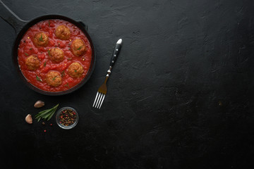 Pan with meat balls in tomato sauce. Flat lay, top view with copy space