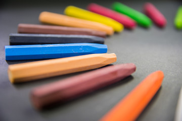 closeup focused crayons in circle on a black background