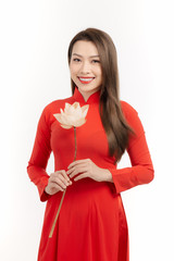 Vietnamese girl holding a lotus flower, The Ao dai ( long-dress Vietnamese) is traditional costume...