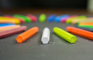 crayons in circle with bottom side in focus on a black background