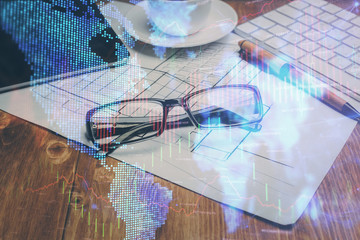 Financial chart hologram with glasses on the table background. Concept of business. Double exposure.