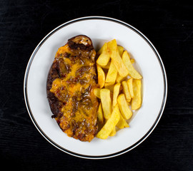 fried meat with grated cheese and french fries