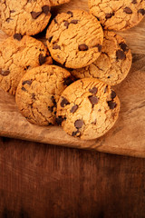 Chocolate chip cookies, gluten-free, shot from the top on a dark rustic background with copy space