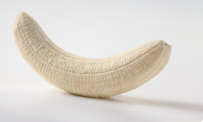 whole peeled banana on a white background