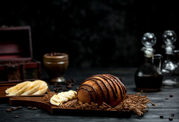 brown bread sprinkled with chocolate syrup and sliced banana