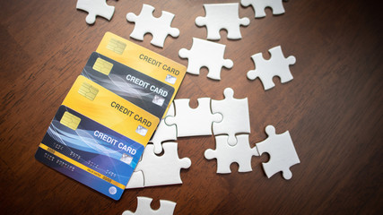Credit cards and puzzles placed on a wooden table