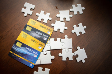 Credit cards and puzzles placed on a wooden table