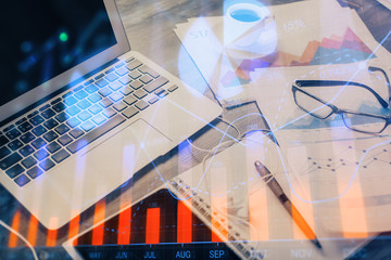 Stock market graph and table with computer background. Multi exposure. Concept of financial analysis.