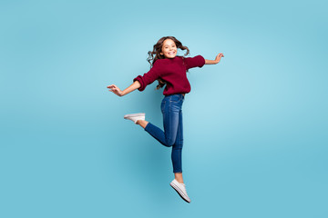 Full length body size side profile photo of cheerful positive smiling toothy beaming girl dancing like ballerina curly wavy jumping isolated vivid blue color background