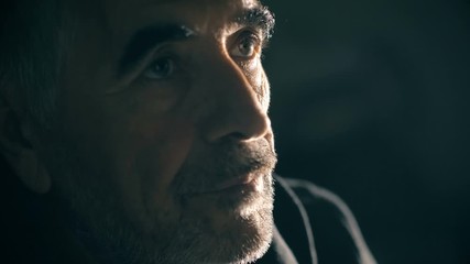 Sad thoughtful lonely mature man in the darkness, thinking his divorce