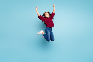 Full length body size photo of positive cheerful curly girl jumping up wearing jeans denim smiling...