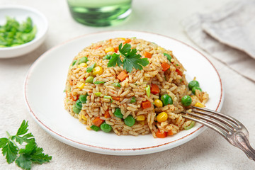 fried rice with vegetables on white plate
