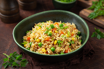 fried rice with vegetables in green bowl
