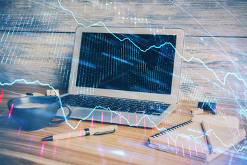 Multi exposure of chart and financial info and work space with computer background. Concept of...