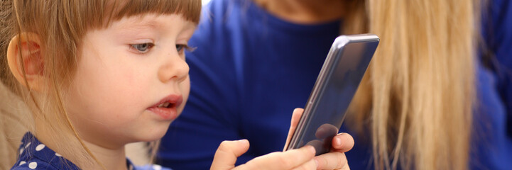 Cute little girl on floor carpet with mom