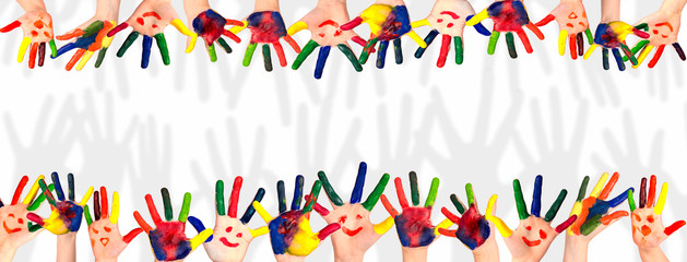 Children's smiling colorful hands raised up. The concept of classroom or back to school