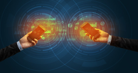 Close up of two smartphones syncing business data