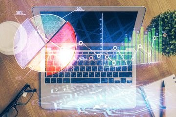 Double exposure of forex graph and work space with computer. Concept of international online trading.