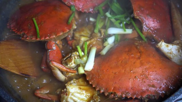Chef cooking Chili Crab Singapore Chinese cuisine iconic dish