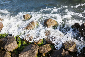 Waves breaking onto a stony seashore.