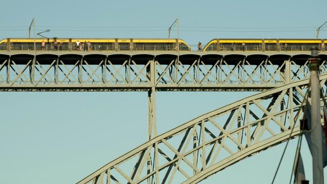 Tram crossing the arch of Ponte Luis in Porto, Portugal 