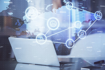 Computer on desktop with social network theme icon. Multi exposure. Concept of international connections.