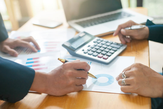 Business team discussing business strategy planning and market share. Businessmen discuss to adjust investment proportions for profit.