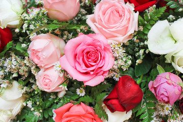 Multicolored roses flowers  patterns blooming with water drops in bouquet background for valentine or wedding card summer top view  scenic background