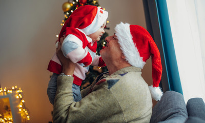 Grandfather gives a christmas present to granddaughter