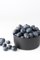 blueberries in cup on white background